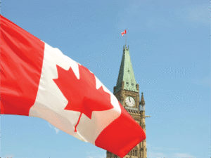 Canadian flag waving in front of the Peace Tower on Parliament Hill in Ottawa