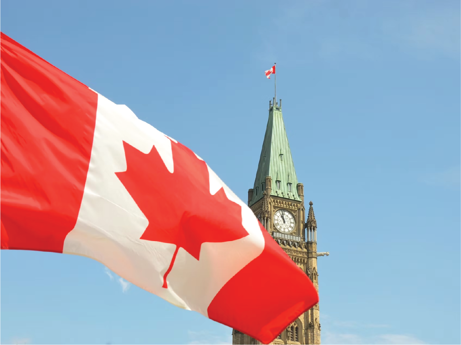 Canadian flag waving in front of the Peace Tower on Parliament Hill in Ottawa